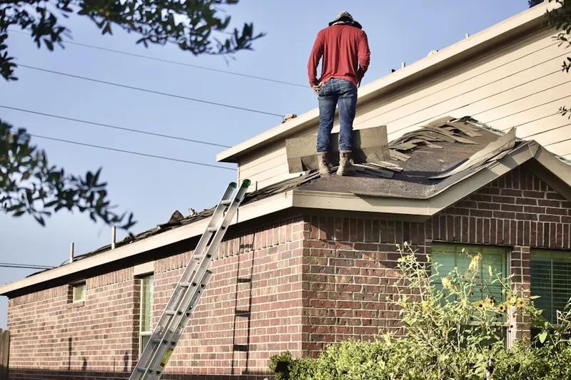 Professional roofer working on a residential roof in Armonk